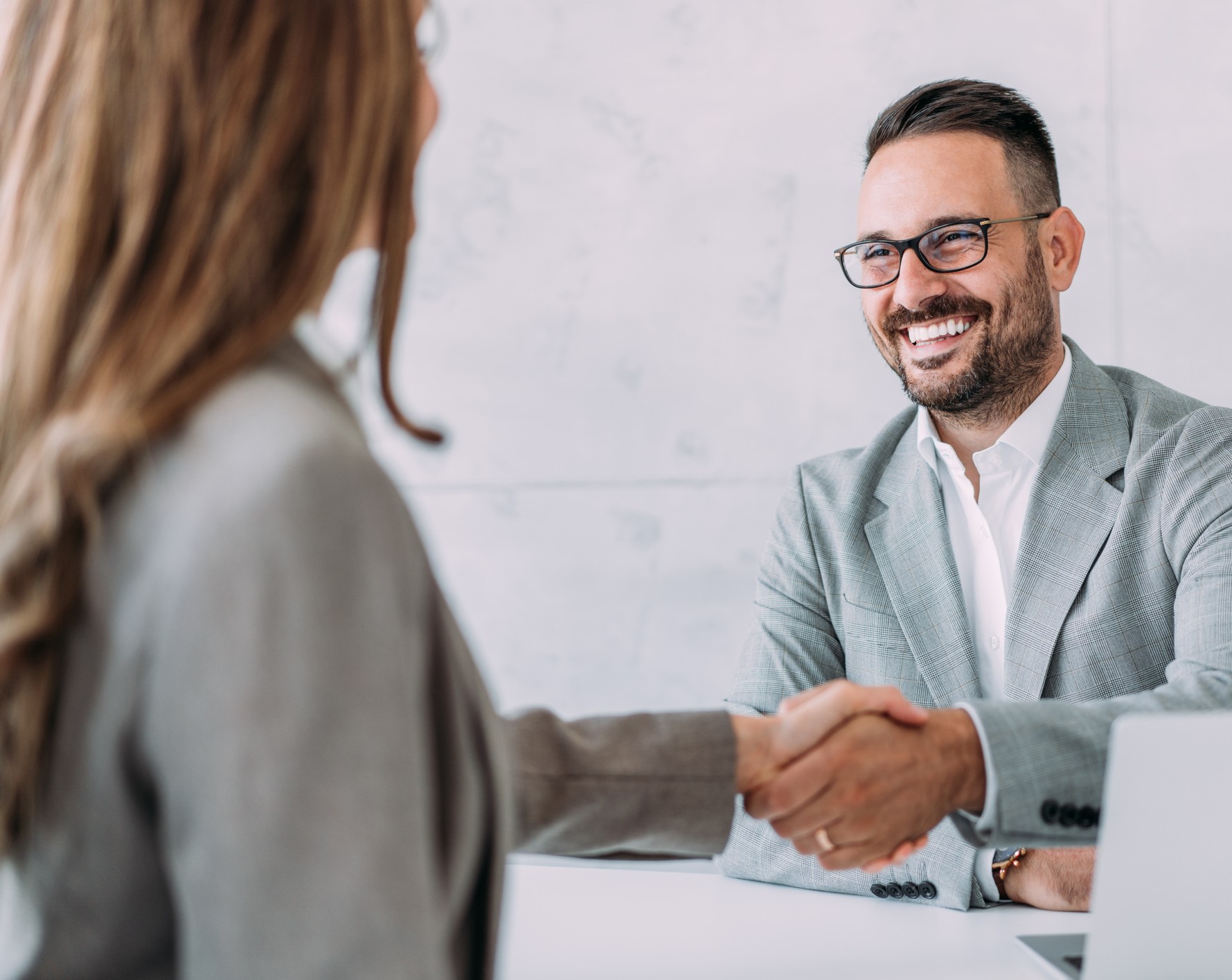female shaking the hand of a male businessman